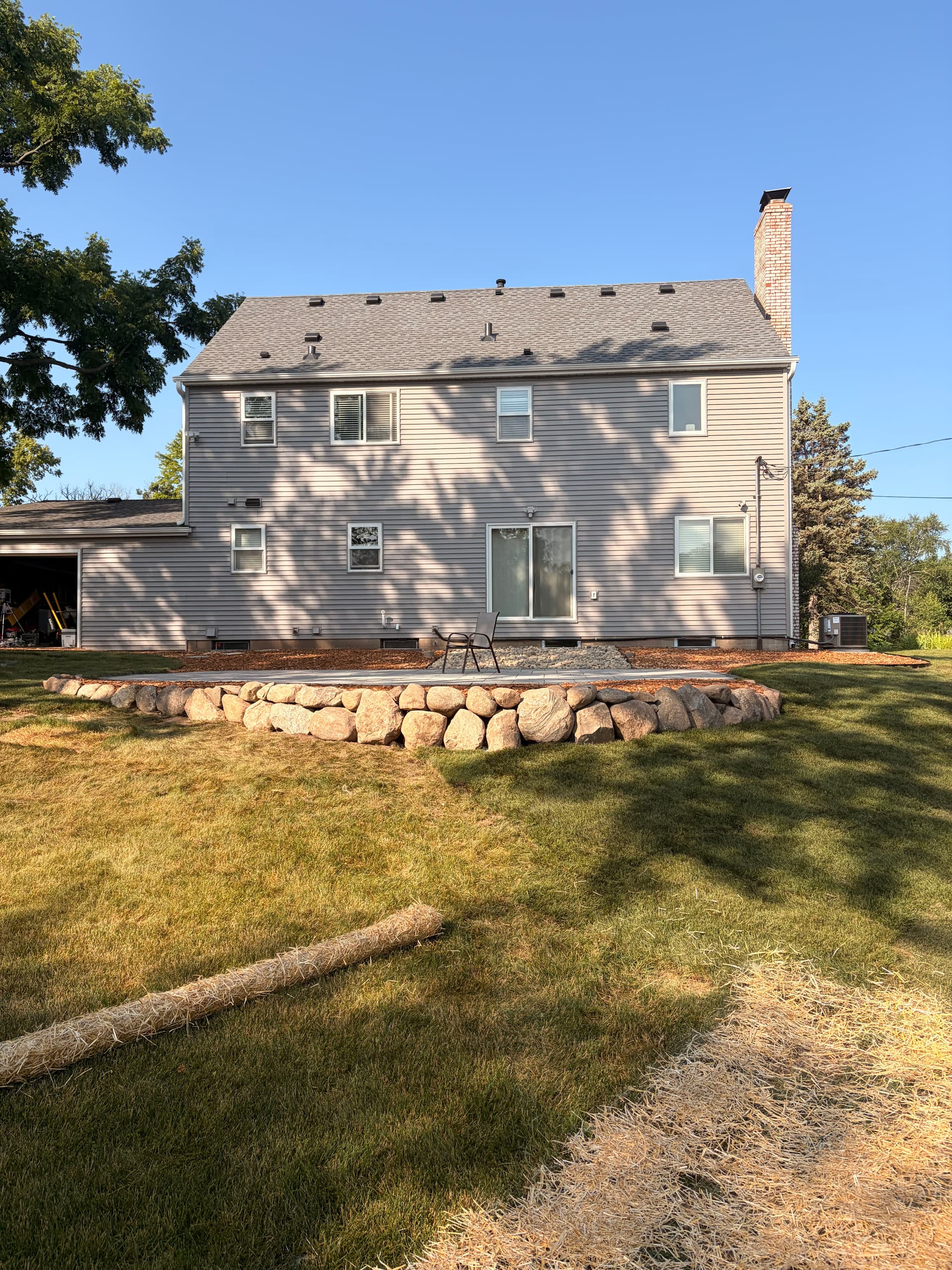 Unilock Patio, Boulder Wall, and Backyard Regrade - Phase 1 Complete image